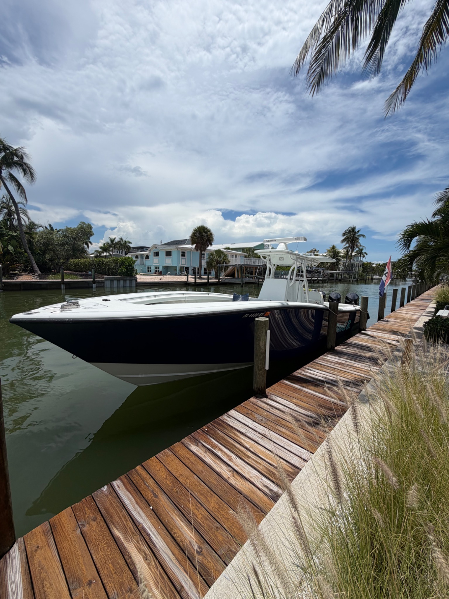 Center console boat at Matanzas Marina dock with palm trees