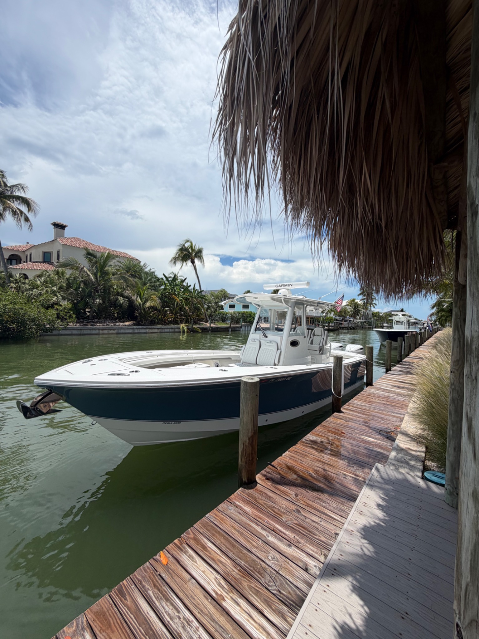 Center console boat docked under thatched palapa roof at Matanzas Marina