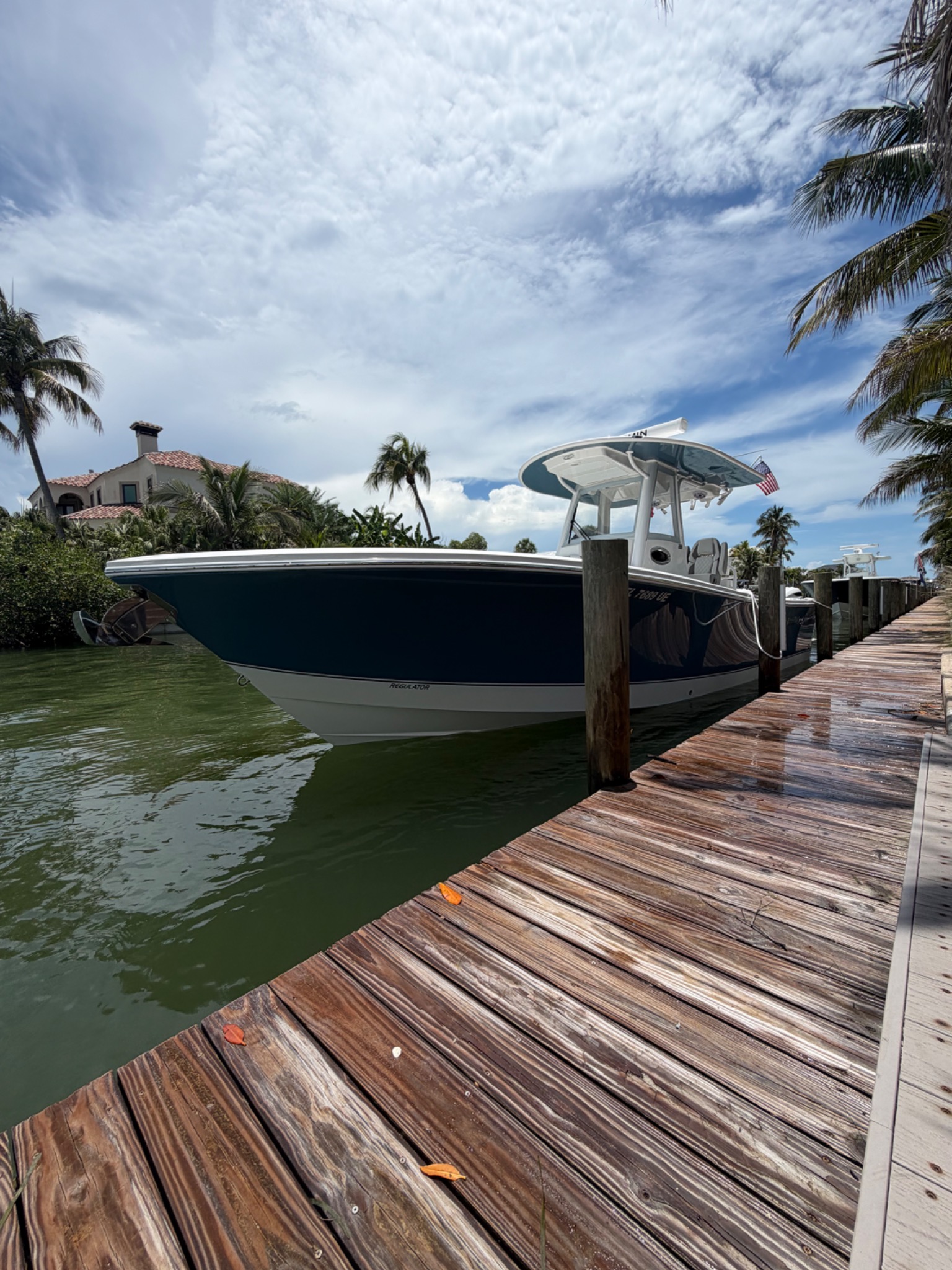 Dark navy blue center console boat bow-on view at Matanzas Marina dock