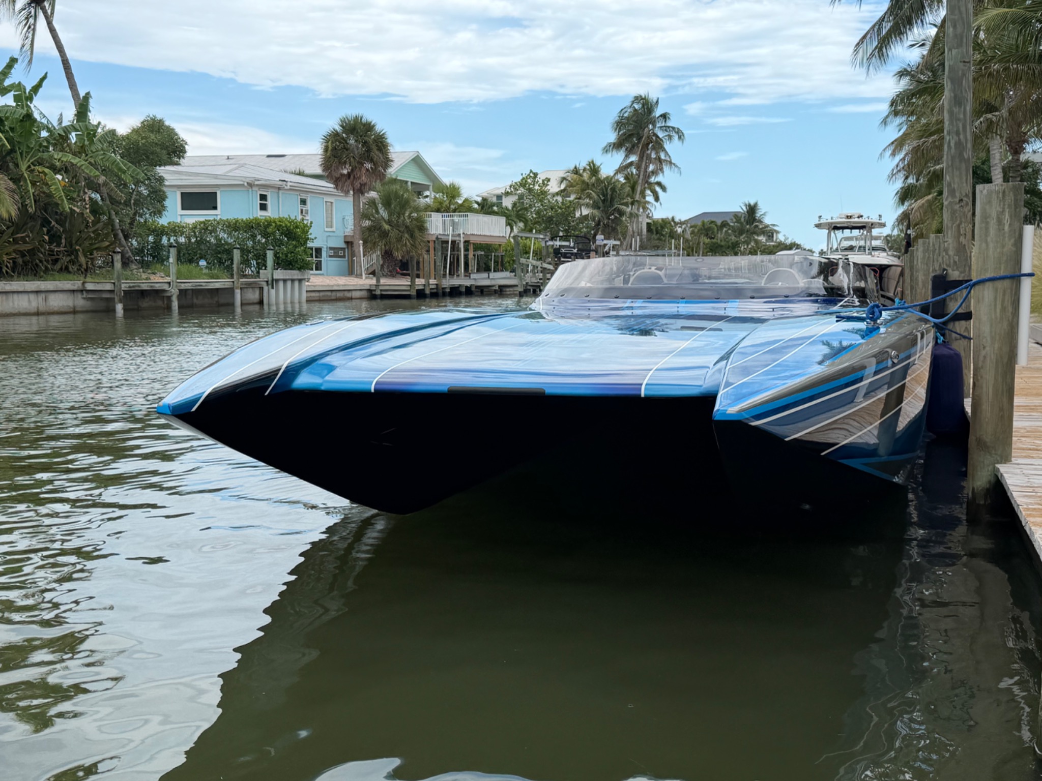 Sleek blue performance boat docked at Matanzas Marina, Fort Myers Beach